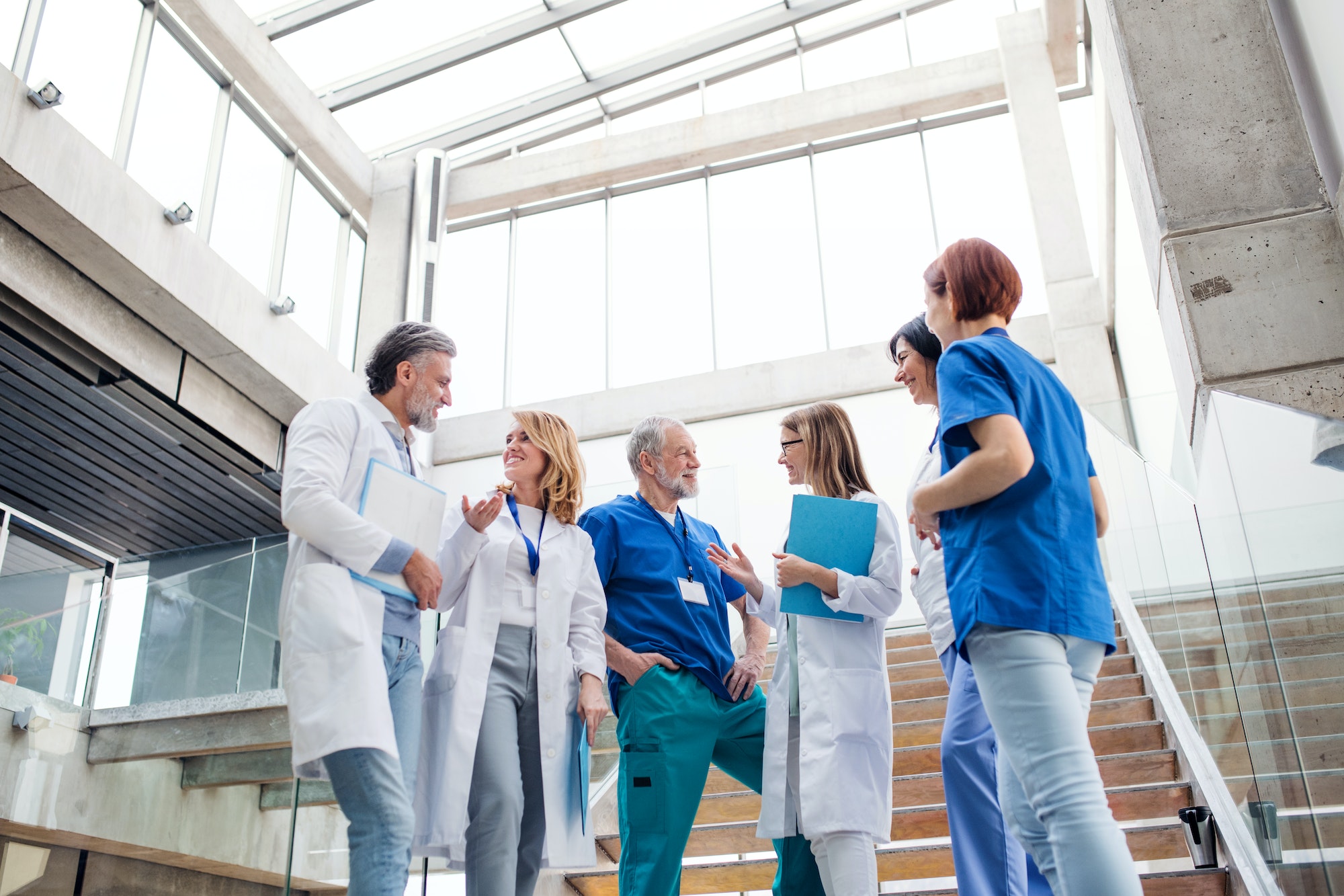 Group of doctors standing on staircase, talking